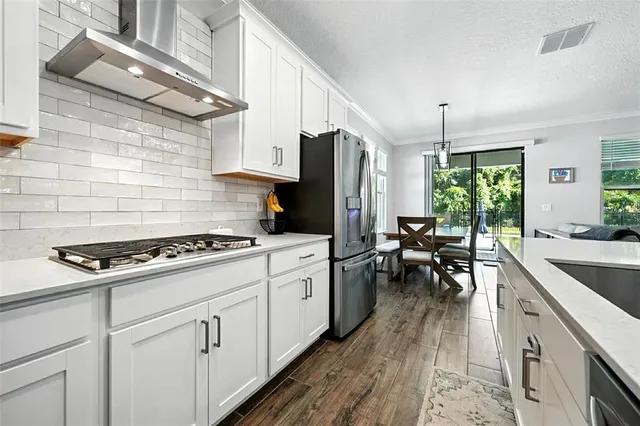 a kitchen with white cabinets and white appliances