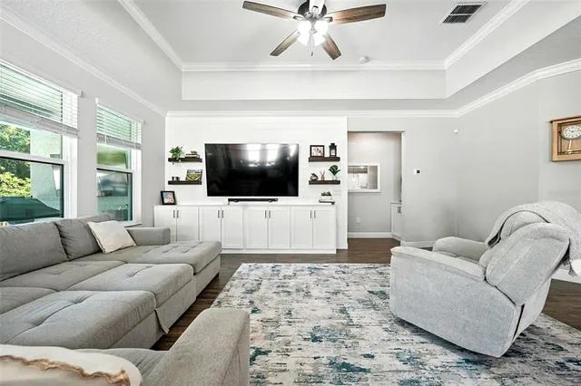 a spacious bedroom with a bed and a flat screen tv