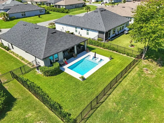 an aerial view of residential houses with outdoor space
