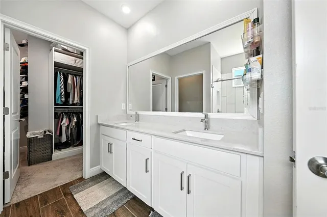 a view of walk in closet with clothes and shoes