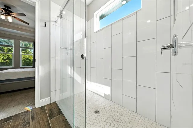 a view of a hallway with wooden floor and a living room