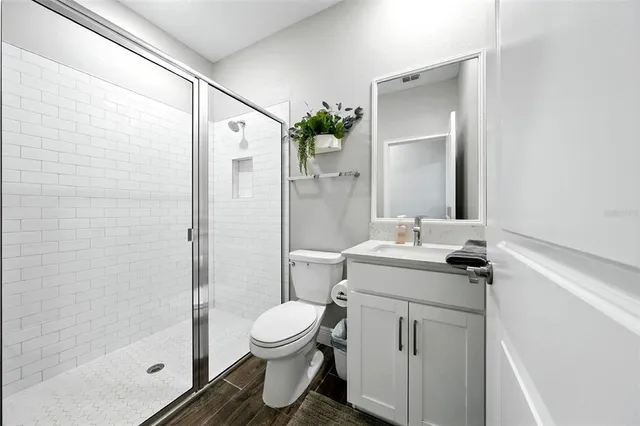 a bedroom that has a bed dresser and a chair