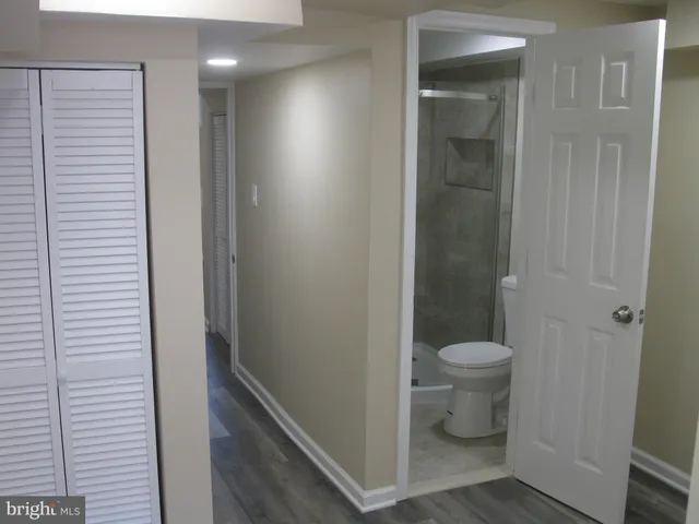 a bathroom with a toilet and a shower