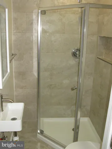 a view of a small space with wooden floor closet and windows
