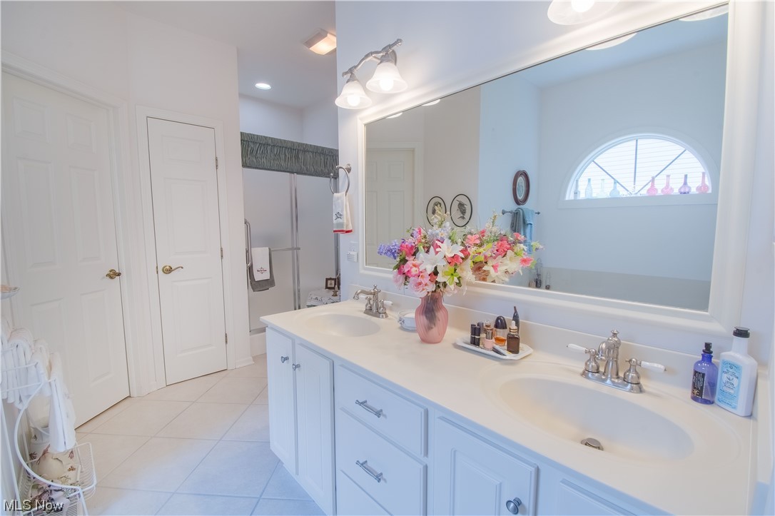 1150 Spring Ridge Circle Alliance, OH 44601 - Photo 19 of 27 The private master bath with a large double vanity, a jetted tub, and a walk-in shower