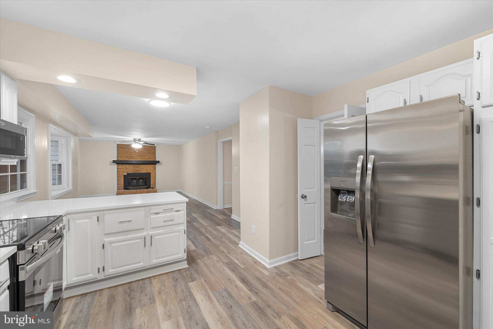 8016 Stillbrooke Road Manassas, VA 20112 - Photo 6 of 41 a kitchen with a refrigerator and a sink