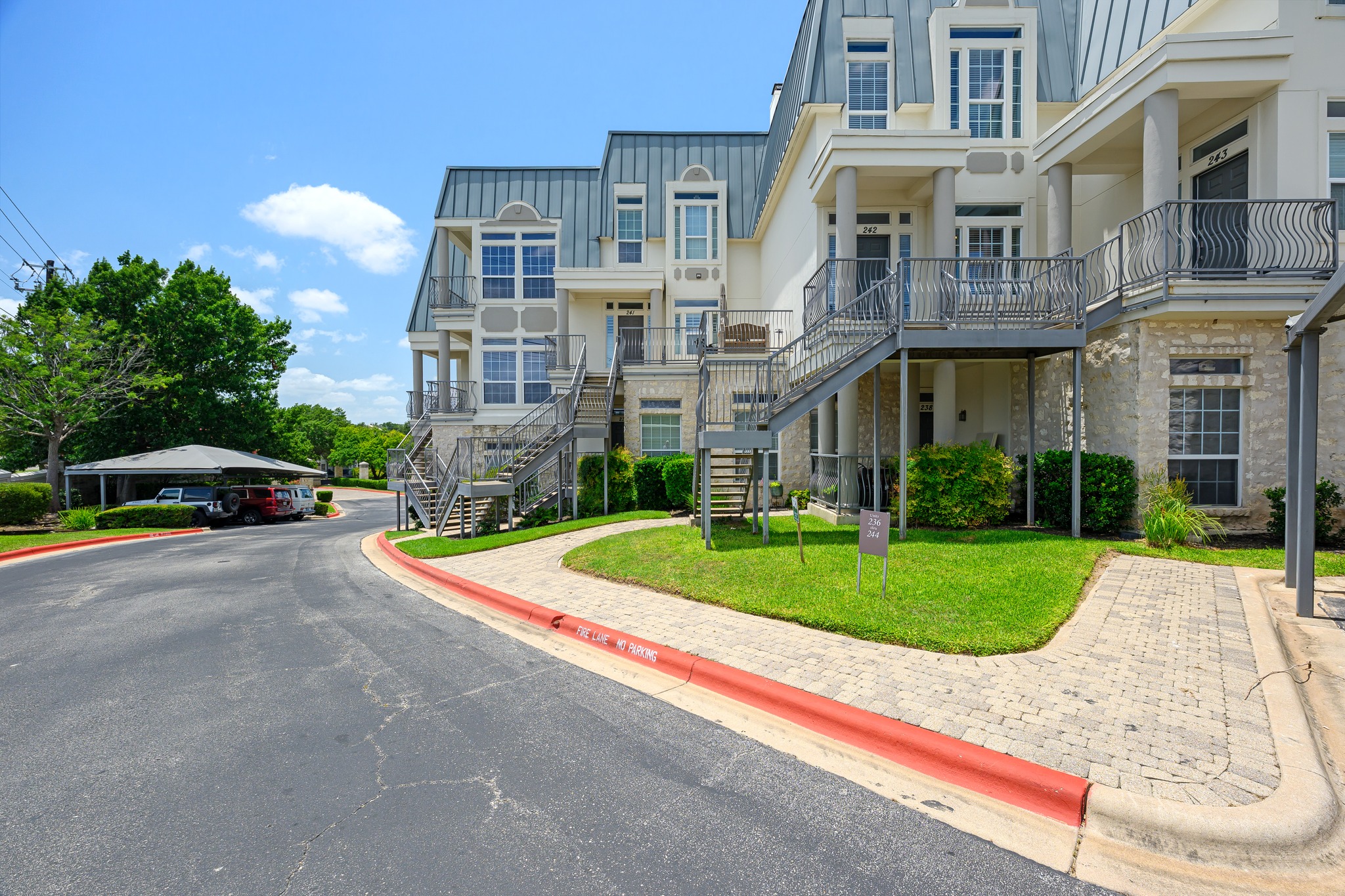 2918 Ranch Road 620 North, Unit S242 Austin, TX 78734 - Photo 2 of 35 Architectural townhomes showcasing multiple levels and inviting outdoor staircases define this charming community.