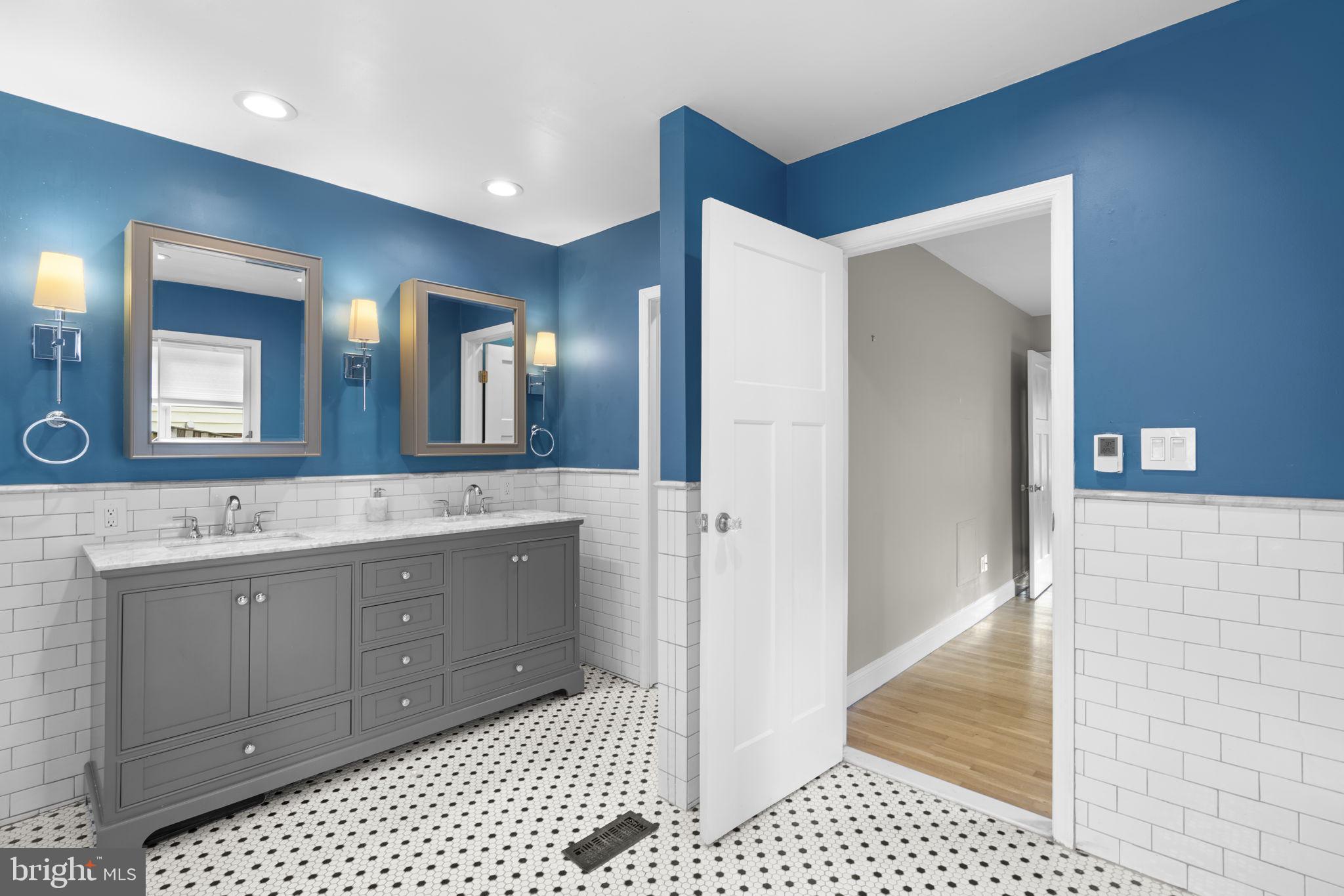 822 Loxford Terrace Silver Spring, MD 20901 - Photo 37 of 61 a spacious bathroom with a double vanity sink a mirror and a shower