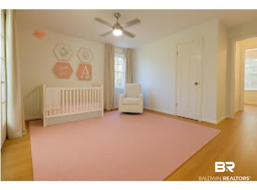 159 Conway Drive West Mobile, AL 36608 - Photo 20 of 24 Unfurnished bedroom with a crib, light wood-style flooring, and ceiling fan