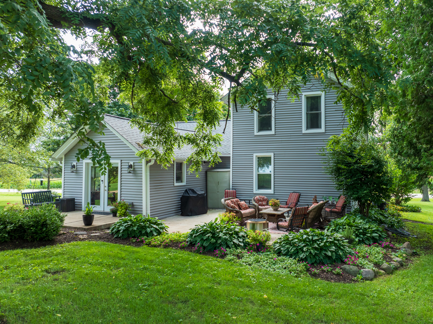 a view of a house with backyard sitting area and garden