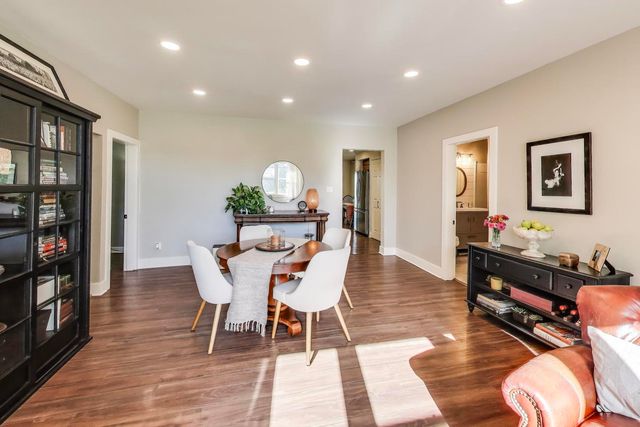 a dining room with furniture and wooden floor