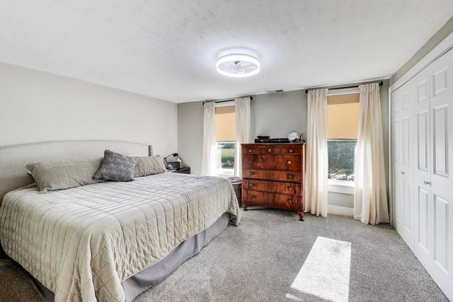 a large bedroom with a bed and furniture