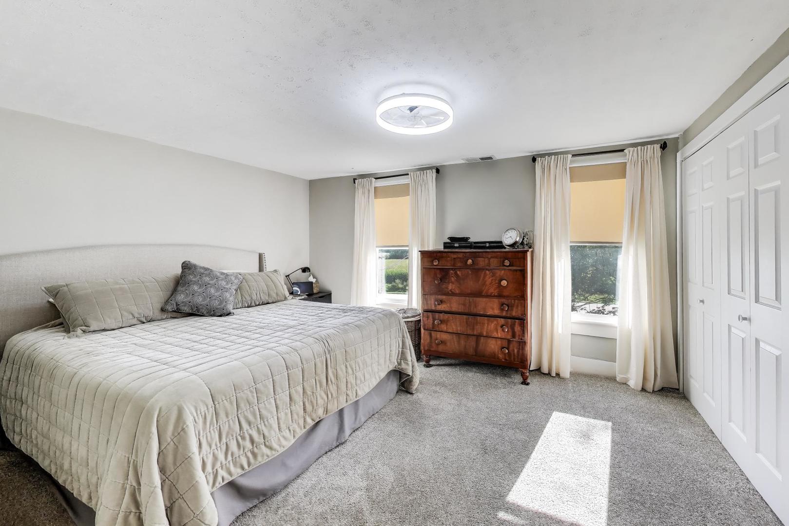 4608 Alden Road Woodstock, IL 60098 - Photo 17 of 42 a large bedroom with a bed and furniture