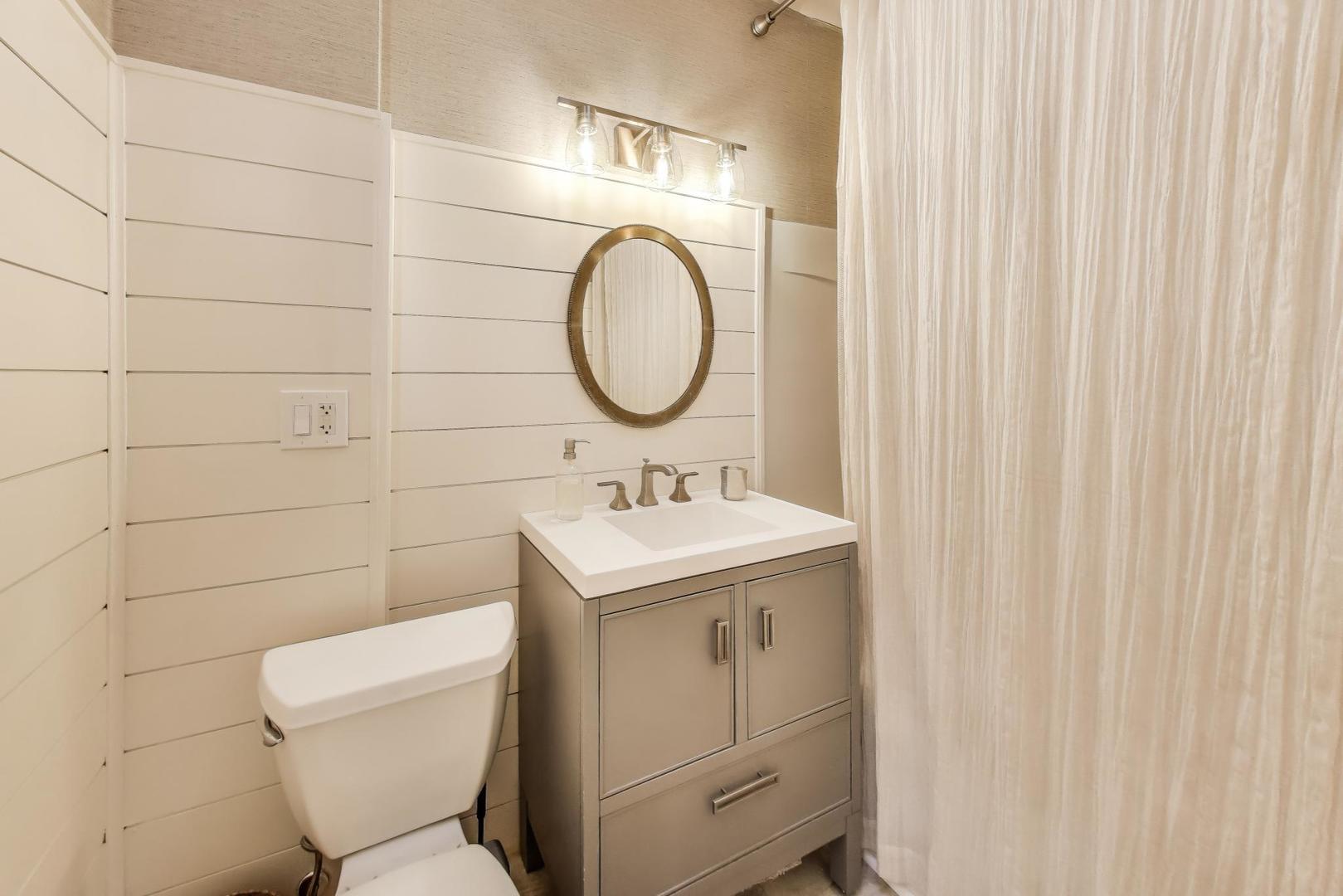 4608 Alden Road Woodstock, IL 60098 - Photo 19 of 42 a bathroom with a toilet sink and mirror