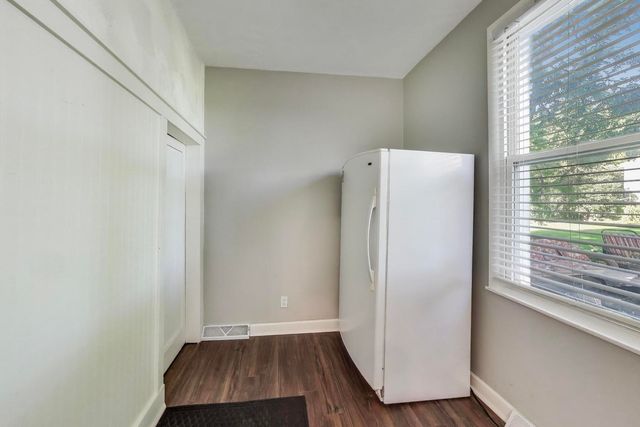 a view of room with window and wooden floor