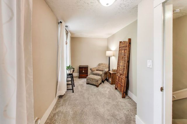 a view of living room with furniture and a flat screen tv