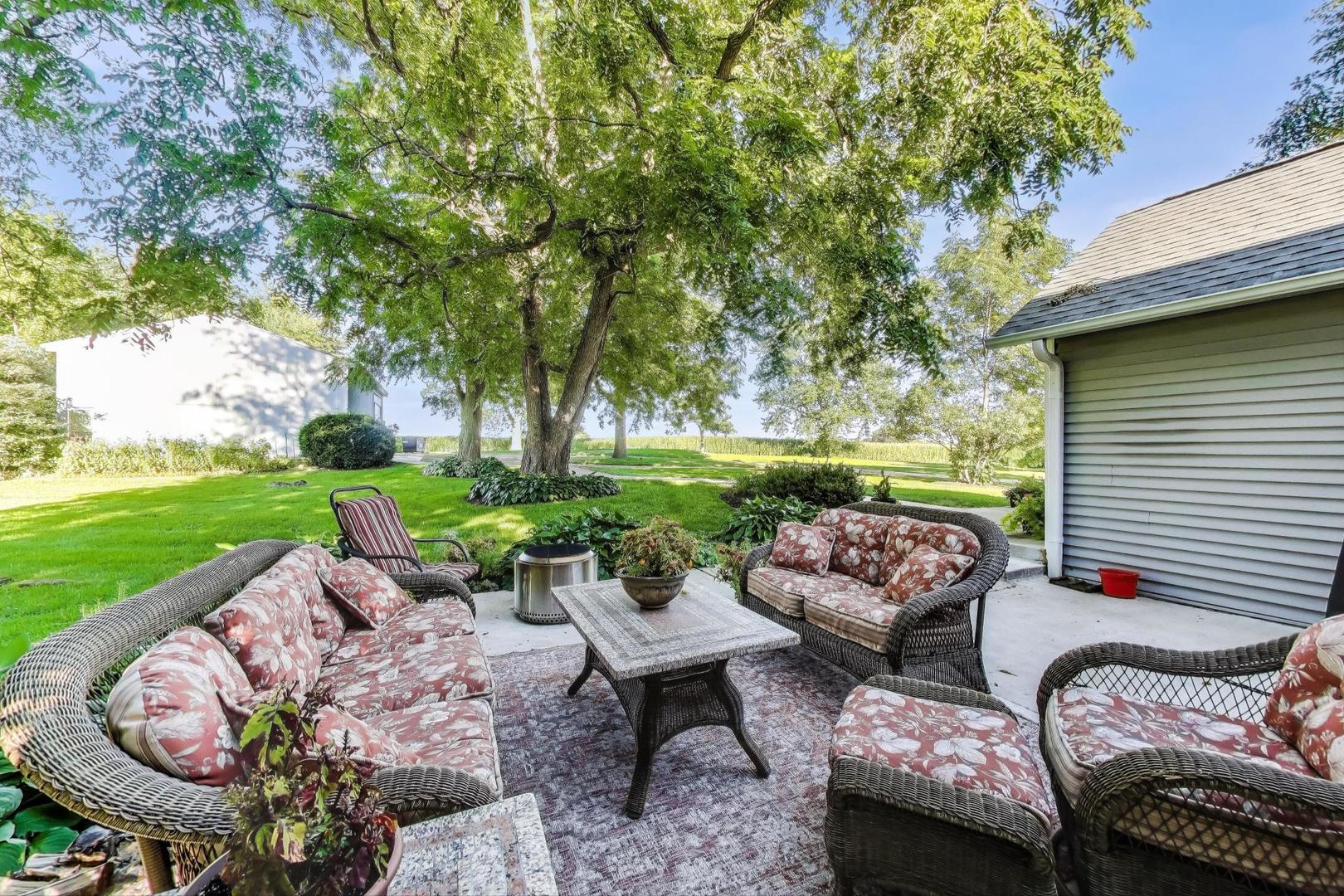 4608 Alden Road Woodstock, IL 60098 - Photo 34 of 42 a view of a patio with couches potted plants and a big yard