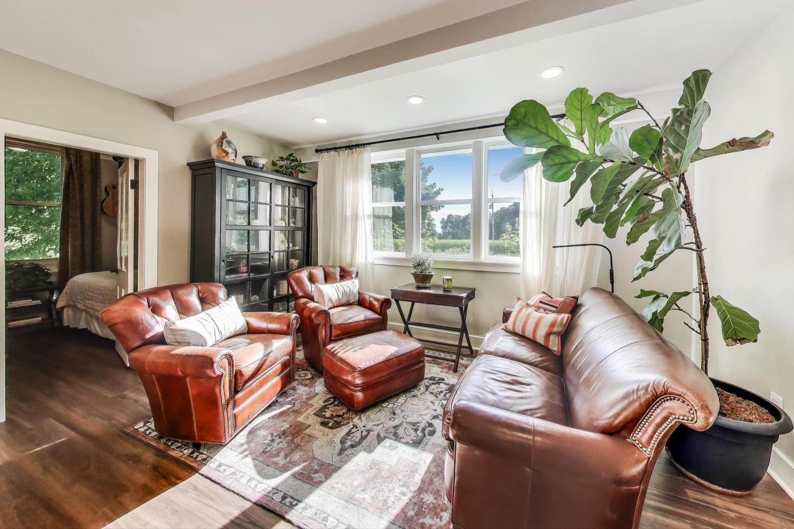 4608 Alden Road Woodstock, IL 60098 - Photo 6 of 42 a living room with furniture a large window and a potted plant