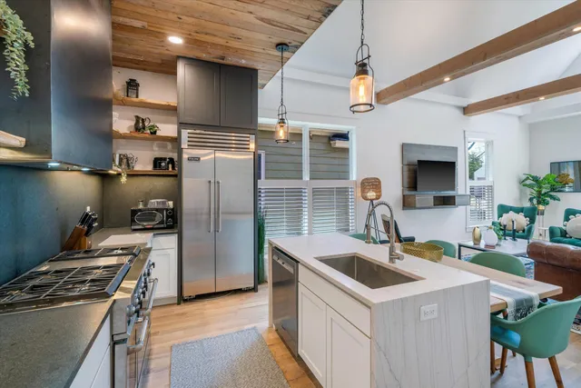 a kitchen with a sink cabinets and wooden floor