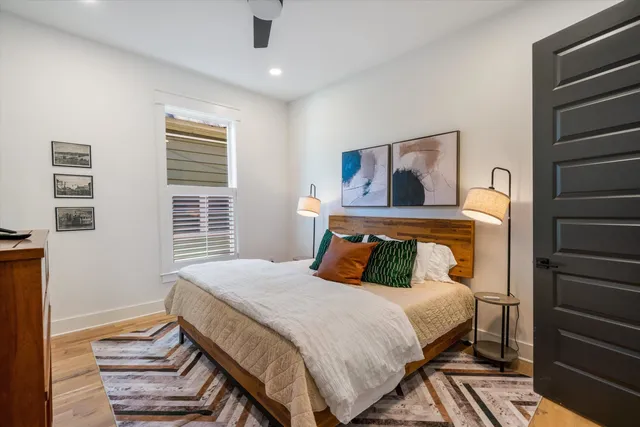 a bedroom with a bed and wooden floor