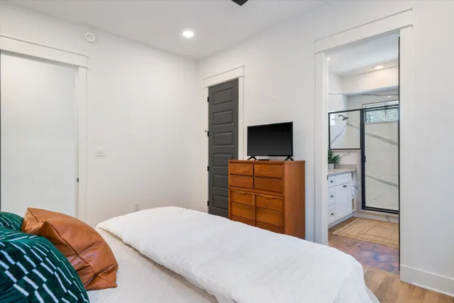 a bathroom with a granite countertop sink mirror and shower