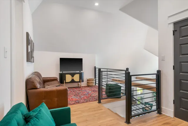 a bedroom with furniture and a flat screen tv