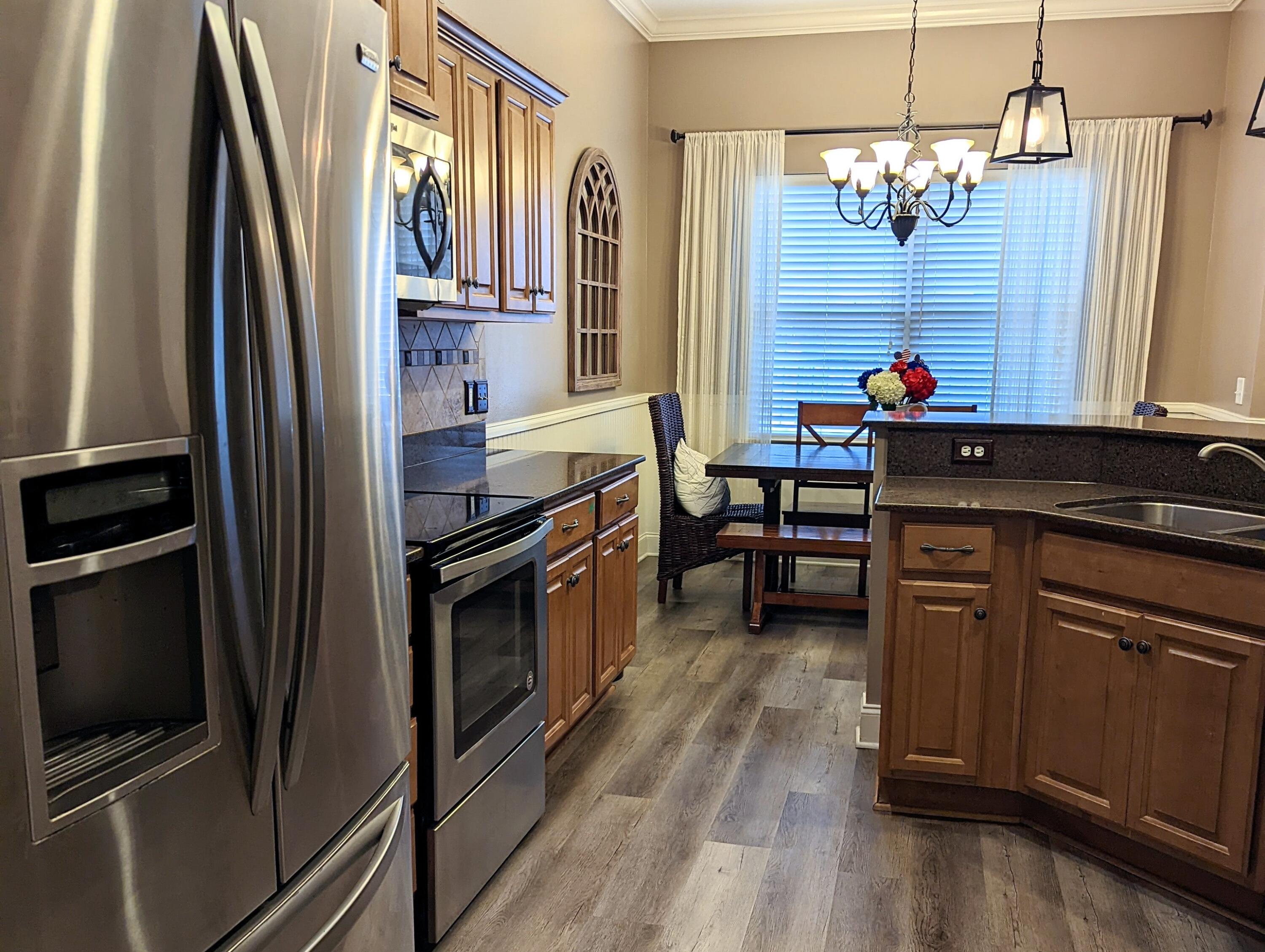 4639 Hermosa Road Crestview, FL 32539 - Photo 4 of 18 a kitchen with stainless steel appliances granite countertop a refrigerator and a stove