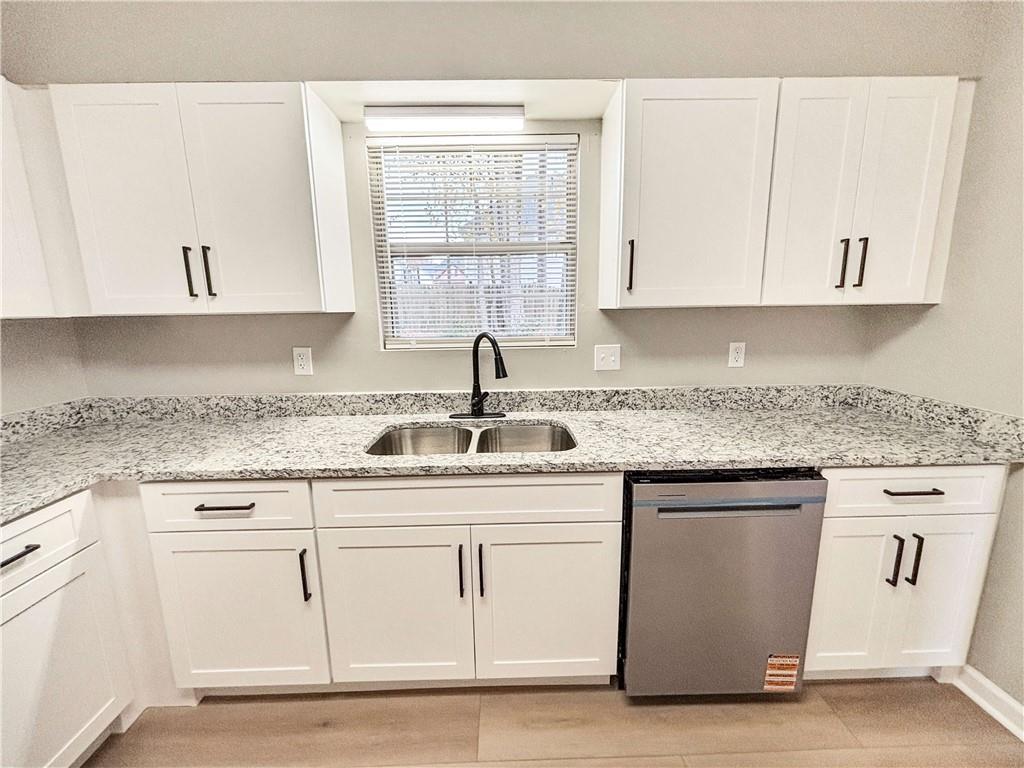 5907 Brookside Drive Southeast Mableton, GA 30126 - Photo 13 of 35 a kitchen with granite countertop white cabinets and a sink