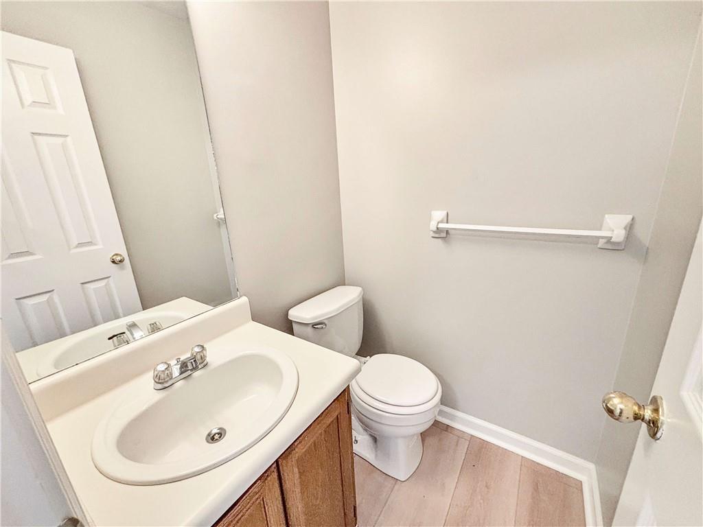 5907 Brookside Drive Southeast Mableton, GA 30126 - Photo 14 of 35 a bathroom with a sink a toilet and a mirror