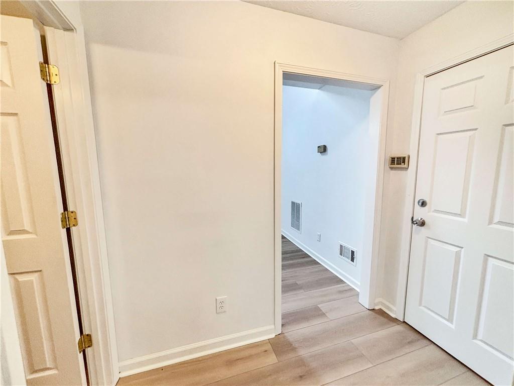 5907 Brookside Drive Southeast Mableton, GA 30126 - Photo 16 of 35 a view of a hallway with wooden floor and staircase