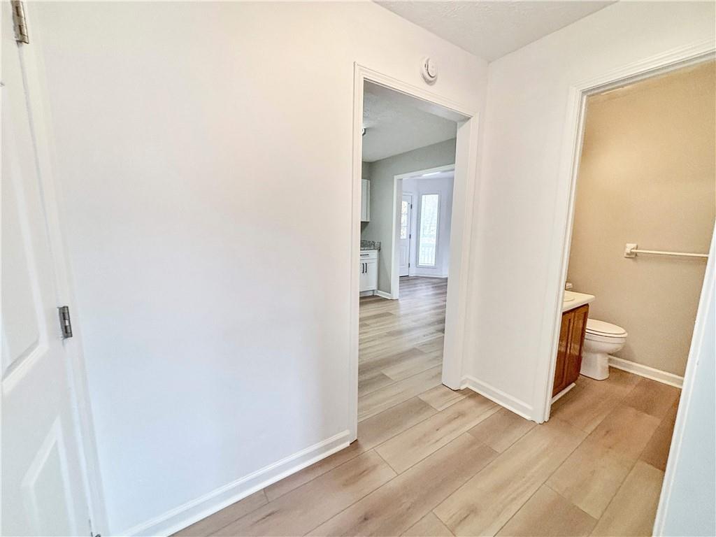 5907 Brookside Drive Southeast Mableton, GA 30126 - Photo 17 of 35 a view of a hallway with wooden floor and a bathroom