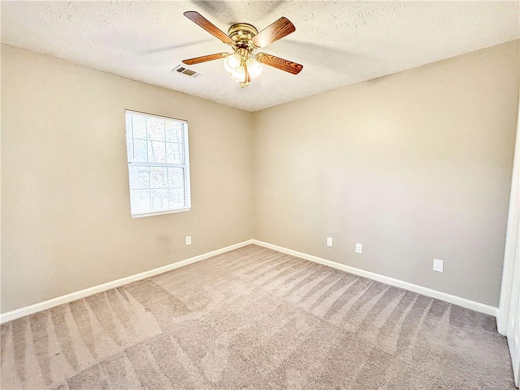 5907 Brookside Drive Southeast Mableton, GA 30126 - Photo 26 of 35 an empty room with windows and a ceiling fan