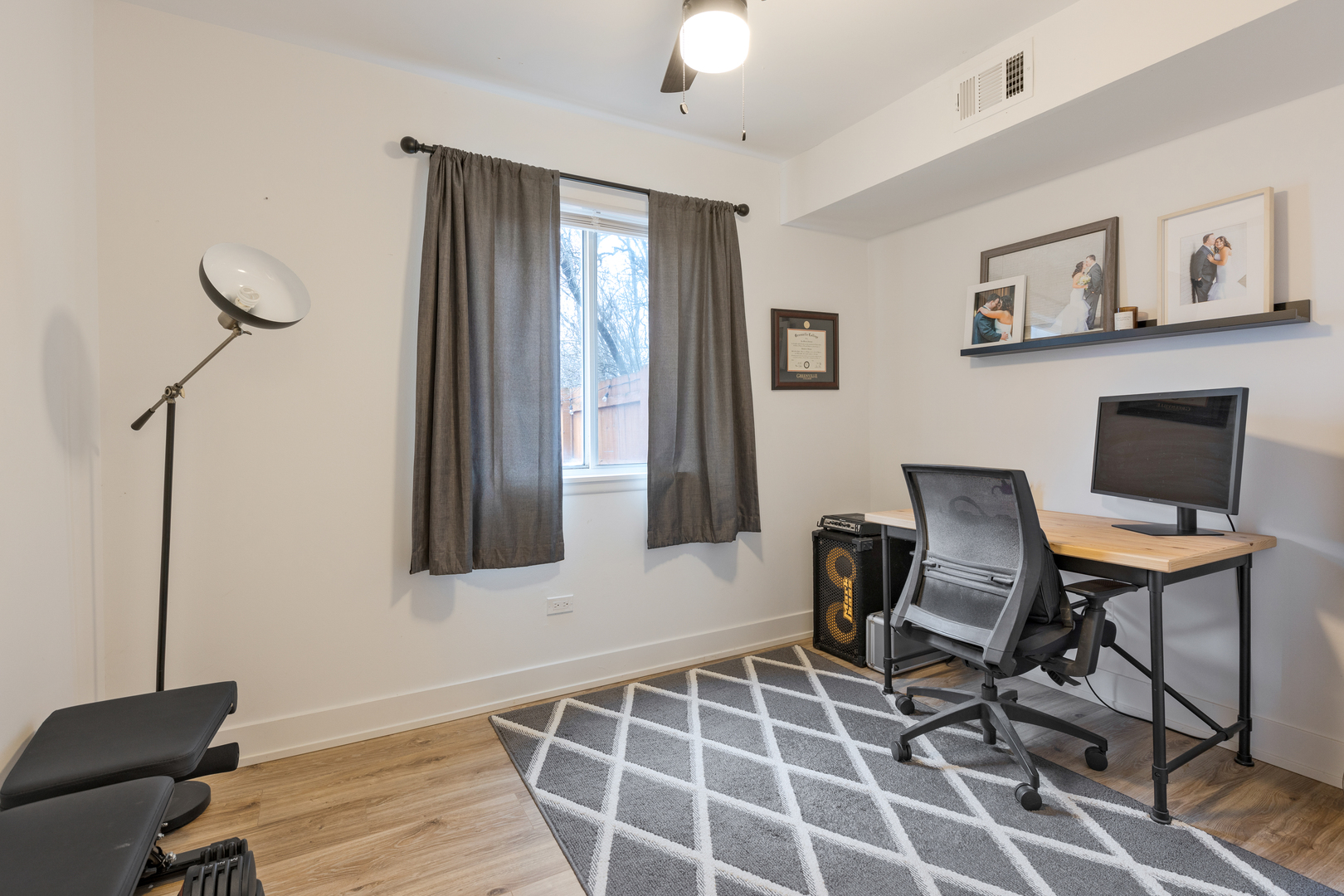 77 Pine Circle Cary, IL 60013 - Photo 11 of 13 a workspace with wooden floor and a bookshelf