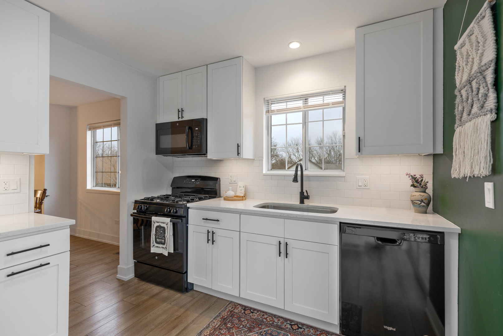 77 Pine Circle Cary, IL 60013 - Photo 5 of 13 a kitchen with a sink stove and cabinets
