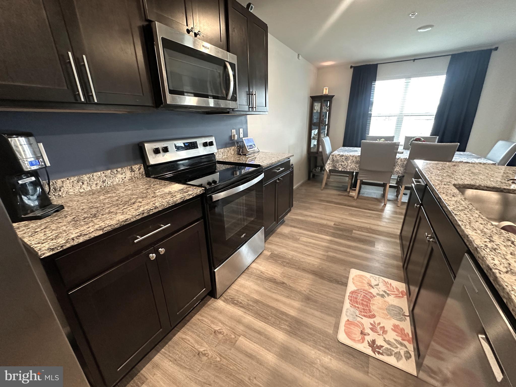 490 Mossy Grove Lane La Plata, MD 20646 - Photo 6 of 20 a kitchen with stainless steel appliances granite countertop sink stove top oven and cabinets