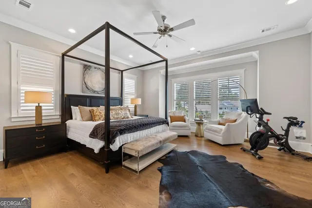 a spacious bedroom with a bed and a ceiling fan
