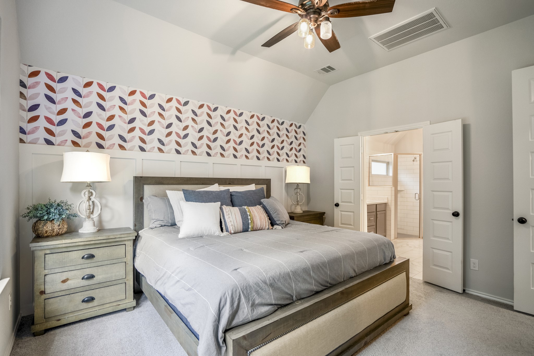334 Topper Pines Drive Montgomery, TX 77316 - Photo 19 of 49 From this angle, we get a better look at the multi-layered accent wall, with wainscoting below, a decorative design above, and the ensuite bath just beyond the bedroom.