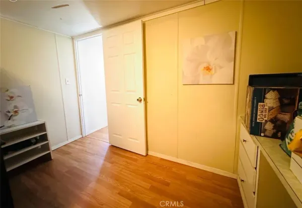a view of a room with wooden floor and cabinet