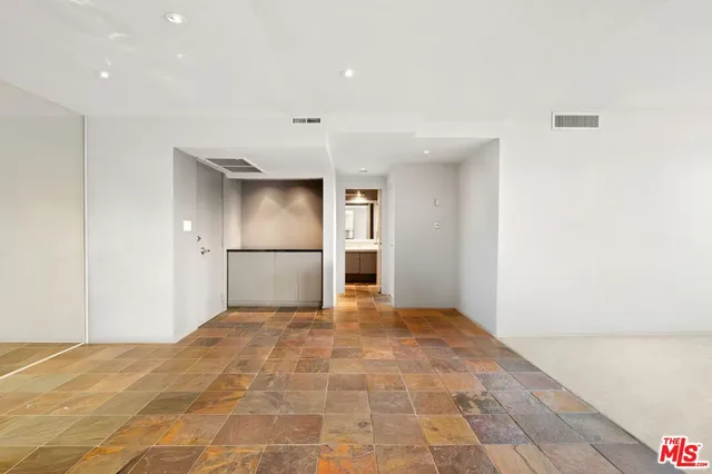 a view of a kitchen with a refrigerator in it