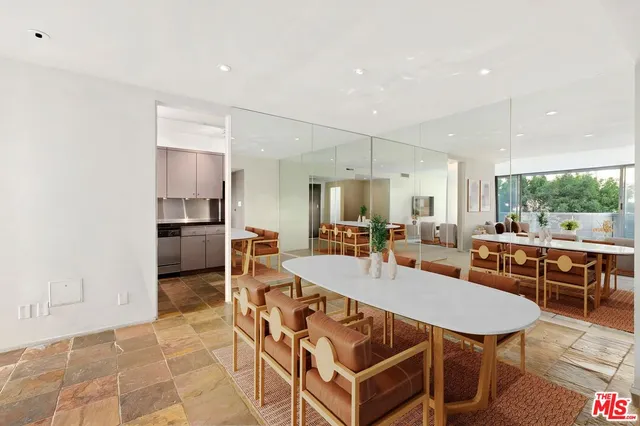 a dining room with furniture and a floor to ceiling window