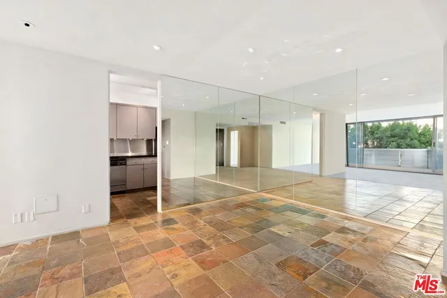 a view of an empty room with a kitchen