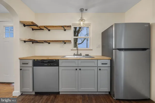 a kitchen with a sink a refrigerator and a stove