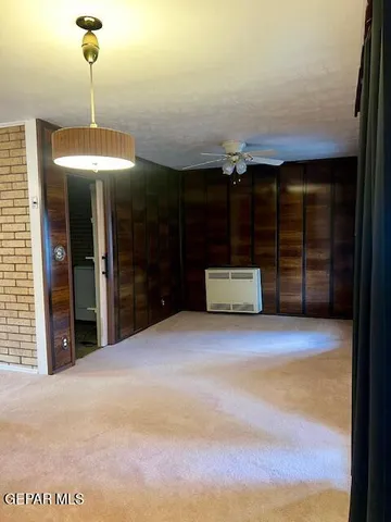 a view of a room with furniture and window