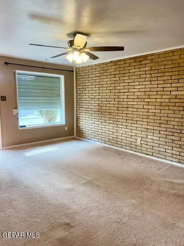 a bedroom with a bed and a ceiling fan