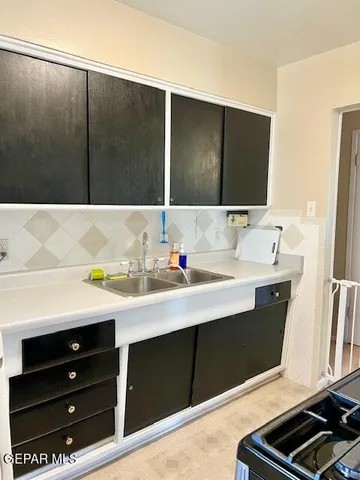 a stove top oven sitting inside of a kitchen