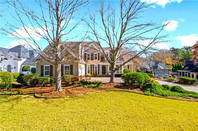 a front view of a building with swimming pool and outdoor seating