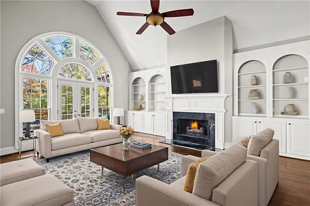 a kitchen with stainless steel appliances granite countertop a stove top oven a sink dishwasher and a refrigerator with wooden cabinets