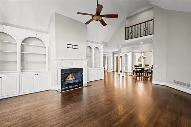 a kitchen with stainless steel appliances granite countertop a stove a sink and white cabinets