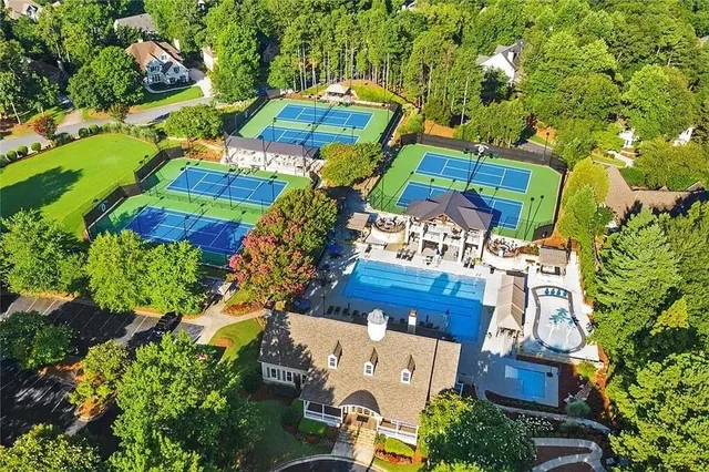 an aerial view of a houses with yard