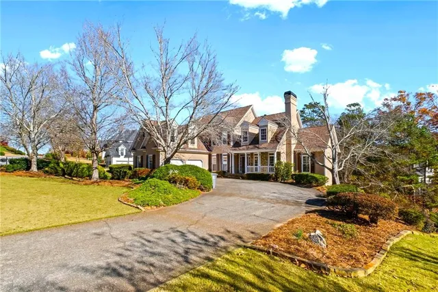 a view of a hallway with wooden floor and a living room